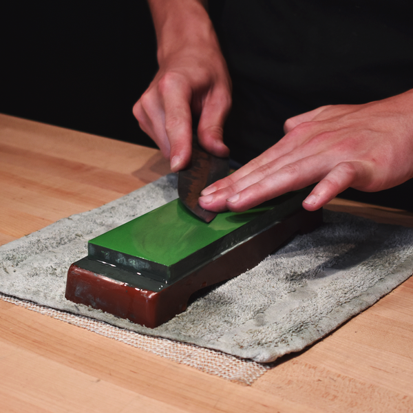  Sharpening knife on whetstone