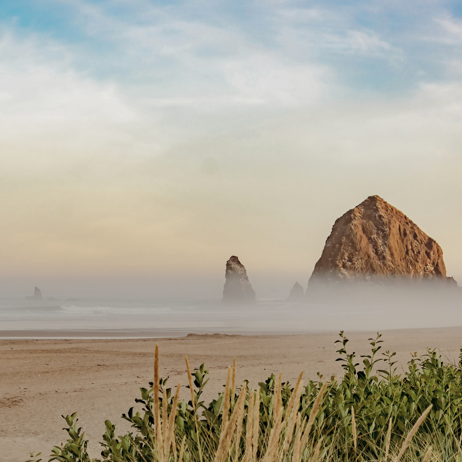 Rocks on a beach with a hazy sky